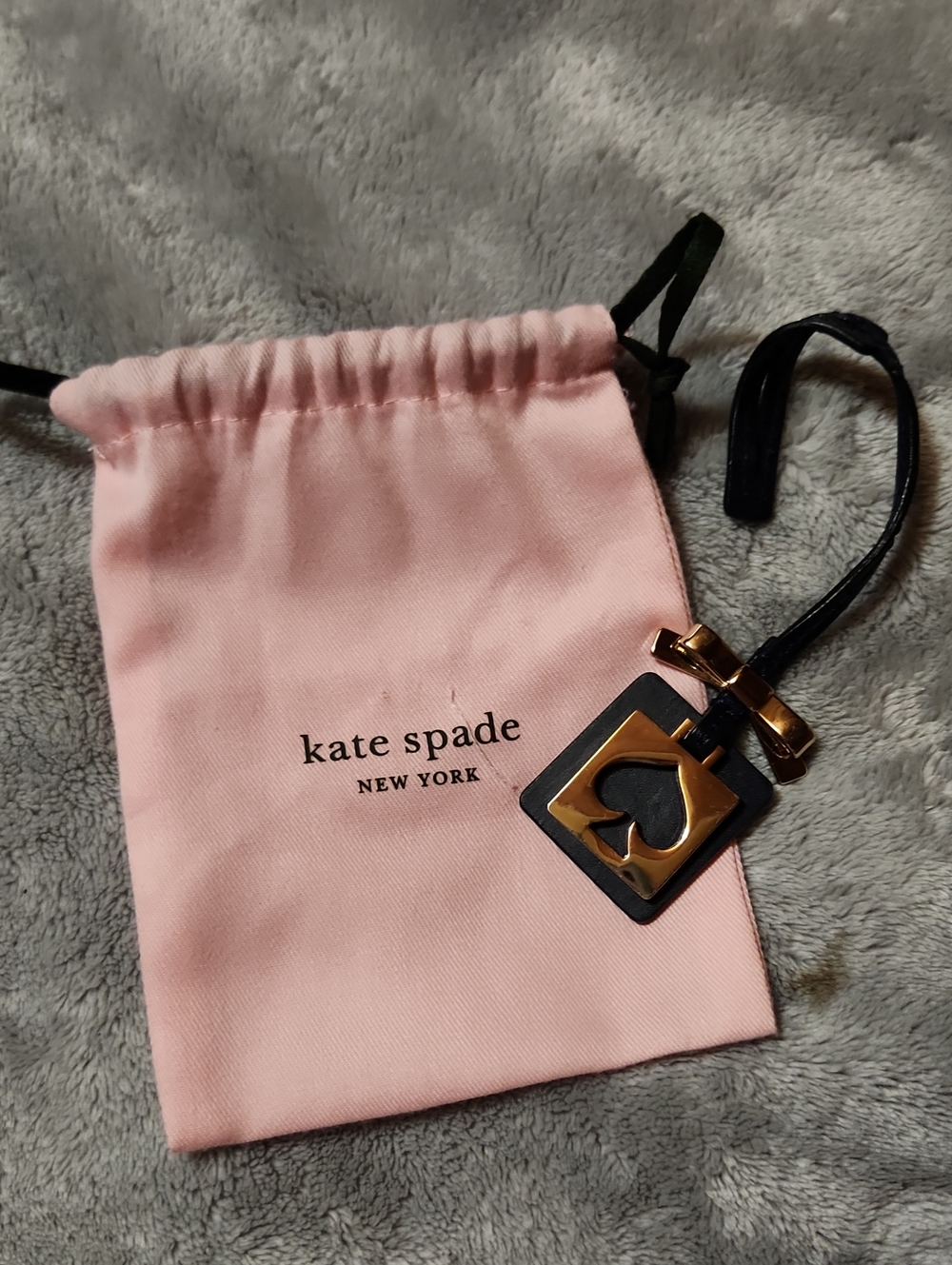 kate spade Pink Drawstring Pouch with Black Strap & Gold-Tone Charm